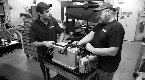 Two engineers in a product laboratory examine a Vanguard battery pack.