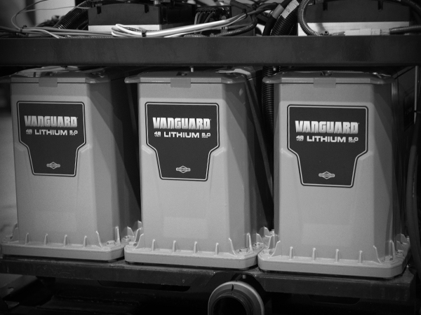 Three Vanguard 48-volt, 5 kilowatt-hour lithium-ion battery packs mounted side by side in a metal rack.