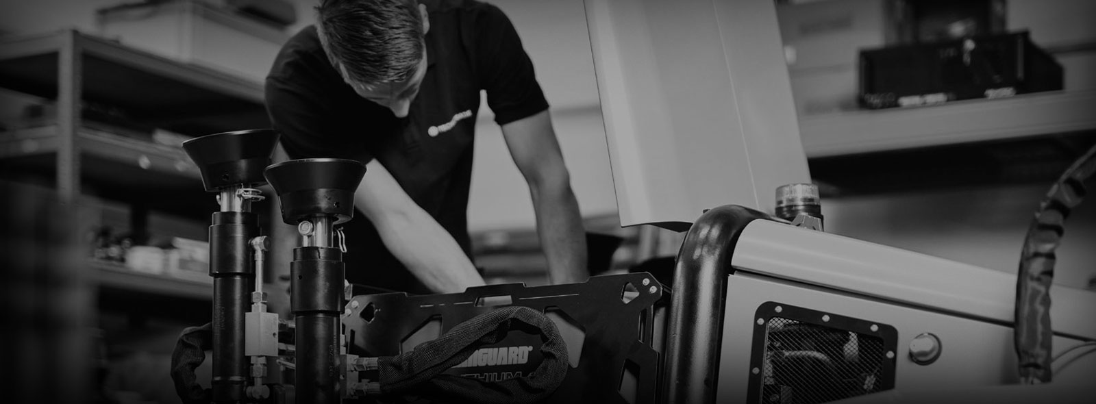 A technician installing a Vanguard battery pack into a piece of equipment.