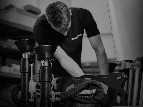 A technician installing a Vanguard battery pack into a piece of equipment.