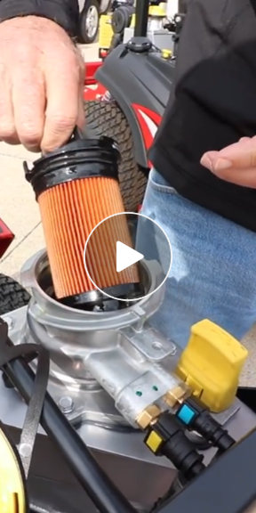 Video Thumbnail showing a man removing an oil filter from a lawn mower engine with the Vanguard Oil Guard system.