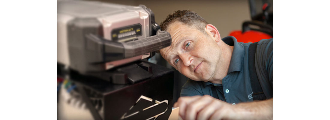  A lithium-ion battery powered commercial lawn mower being charged.